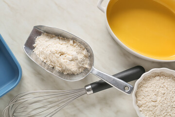 Kitchen utensils for preparing bakery and flour on light background