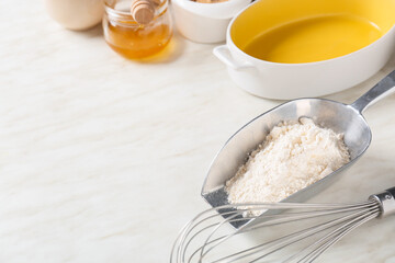 Set of kitchen utensils and ingredients for preparing bakery on light background