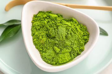 Bowl with powdered matcha tea on tray, closeup