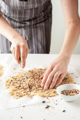 A woman cooks vegan cookies. Healthy food. Homemade sweets. Experiments with food. Vertical photo.