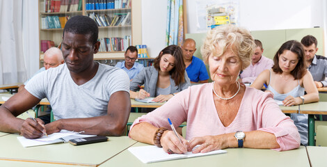 Fototapeta na wymiar African American man and woman take a written exam in the classroom