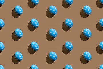 Easter seamless pattern. Festive banner. Holiday design. Cute art. Abstract background. Blue eggs with white spotted ornament isolated on beige.