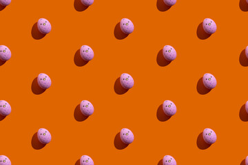 Easter seamless pattern. Cute egg art. Festive decor. Holiday gift card. Abstract background. Pink paschal symbol with painted poult isolated on orange.