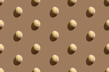 Easter pattern. Traditional seamless banner. Holiday decoration. Abstract background. Yellow eggs with pink spotted ornament isolated on beige.