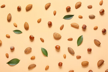 Fototapeta na wymiar Healthy hazelnut and almond nuts on color background
