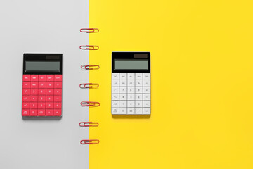 Modern calculators on color background
