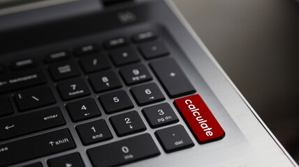 Fototapeta na wymiar Calculate word on laptop keyboard red button. Concept for business and financial.
