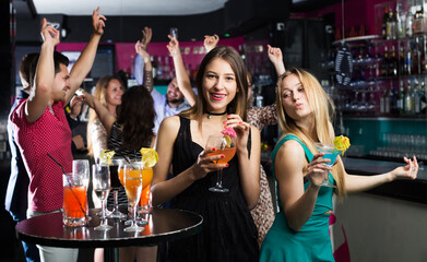 Glad Teenagers celebrating end of session in the bar at evening