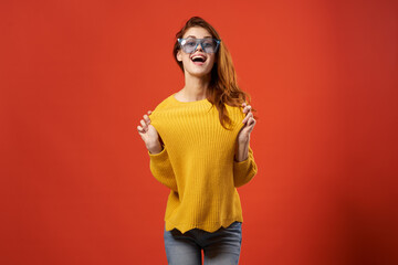 cheerful woman yellow sweater glasses fashion clothes studio red background