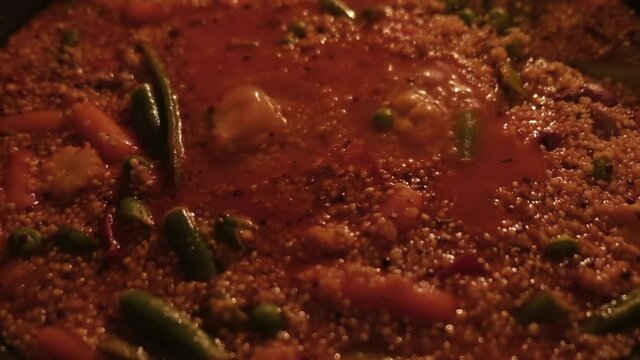 Seething boiling delicious with tomato quinoa paste with vegetables. A bubbling vegetarian dish of Peas, Beans, Corn, Peas, Quinoa. A terrible, scary soup.