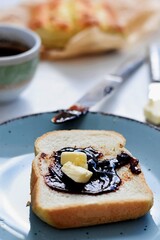 Bread toast whit fruit jam/marmalade and butter/ Breakfast table/ Delicious toasted bread whit cup of coffee served for breakfast