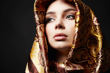 girl in golden scarf. beautiful young woman with make-up