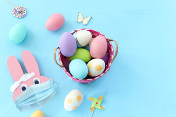 Cute bunny with medical mask. Top view, Flat lay. Coronavirus prevention concept