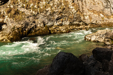 Green moss wall in Abkhazia, mountain textures, stone, water. Beautiful background. The texture of moss and stone.