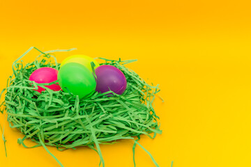 Four Colorful Easter Eggs Sitting in Green nest or Grass.Copy space.