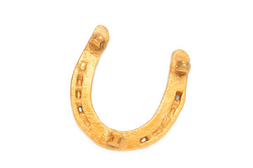 Gold horseshoe isolated on a white background