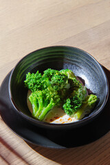 Boiled broccoli in a plate on a background with a copy of space