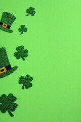 St Patricks Day frame of leprechaun hats and shamrock four leaves clover on green background. Saint...