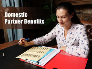 Fototapeta premium Business concept about Domestic Partner Benefits Female office workers with yellow shirt holding and writing documents on office desk
