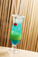 blue cocktail with cherry