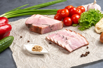 Traditional cutting of smoked pork belly on paper with fresh vegetables and mustard. Still life of food