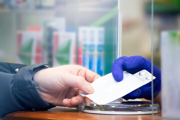 Pharmacist working. Protection in pharmacies. Working in an Alarm State. Protection against coronavirus.