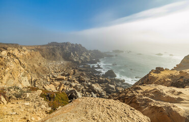 Beautiful landscape, rocks and ocean views and heavy fog along the Pacific Highway in northern California.
