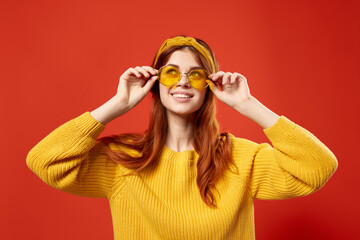 pretty woman wearing glasses yellow sweater emotions casual wear red background