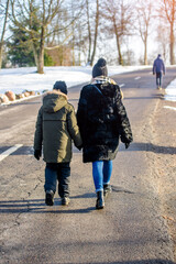 A woman with her son walking in a winter Park
