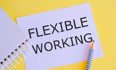 FLEXIBLE WORKING text written on white paper on yellow background. Concept of non traditional working