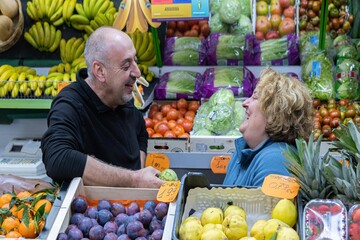 Two fruit sellers talking at the fruit store
