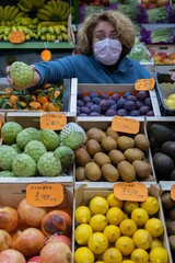 Fruit seller serving her customers