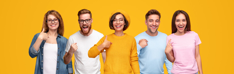 Cheerful young people pointing at themselves
