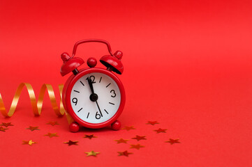 Red alarm clock on red background