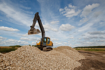 Crawler excavator during work. Bucket Crawler excavator on a summer sky background. Concept -...