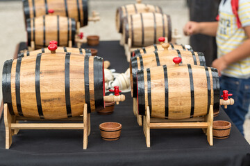  Wine tasting from wooden barrels at Madeira Wine Festival in Funchal.