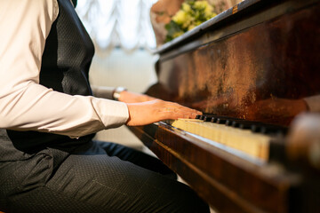 A wedding photo, a guy playing an old piano.