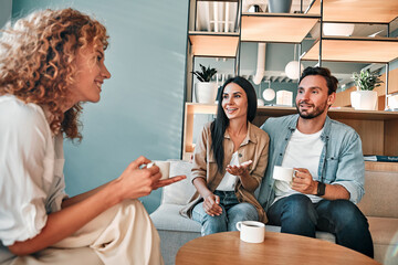 Smiling businesswoman having meeting with clients in cafe