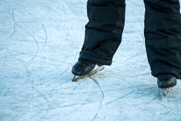 Fototapeta na wymiar Close-up of legs in ice-skates