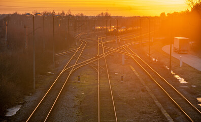 Fototapeta na wymiar Railway junction and standing tanks at sunset