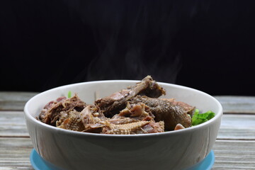 Traditional soup of steamed duck and chicken meat serving with fresh vegetable in the bowl. Famous hot bowl menu in Chinese restaurant. 