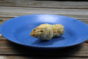 Selective focus, Worm in the corn cob on the plate. 