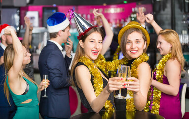 Young friends dancing on new year party with a cocktails