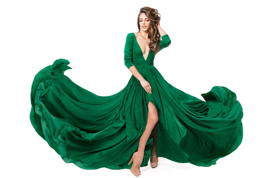 Woman Green Fashion Dress. Model In Long Evening Slit Gown Waving On Wind. Fashionable Beauty Girl Dancing On Isolated White Background