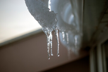 Naklejka na ściany i meble icicles hanging from a roof
