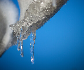 icicle hanging from the roof at the same winter