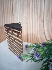 Obraz na płótnie Canvas A slice of chocolate spartak cake or chocolate honey cake. Selective focus points. Blurred background