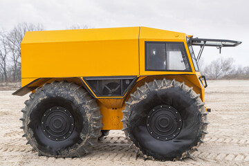 Ultimate all-terrain vehicle with huge big tires and strong yellow metal body