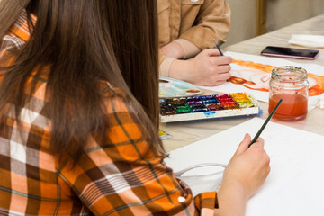Creativity workshop, art education. Creative hobby. Art lesson. Female hand with paintbrush