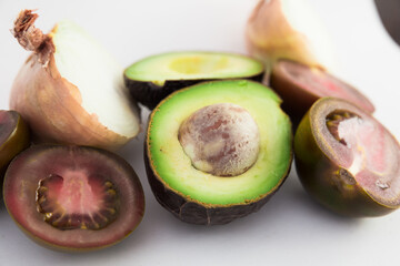 vegetables black tomatoes, avocado and onions on white background